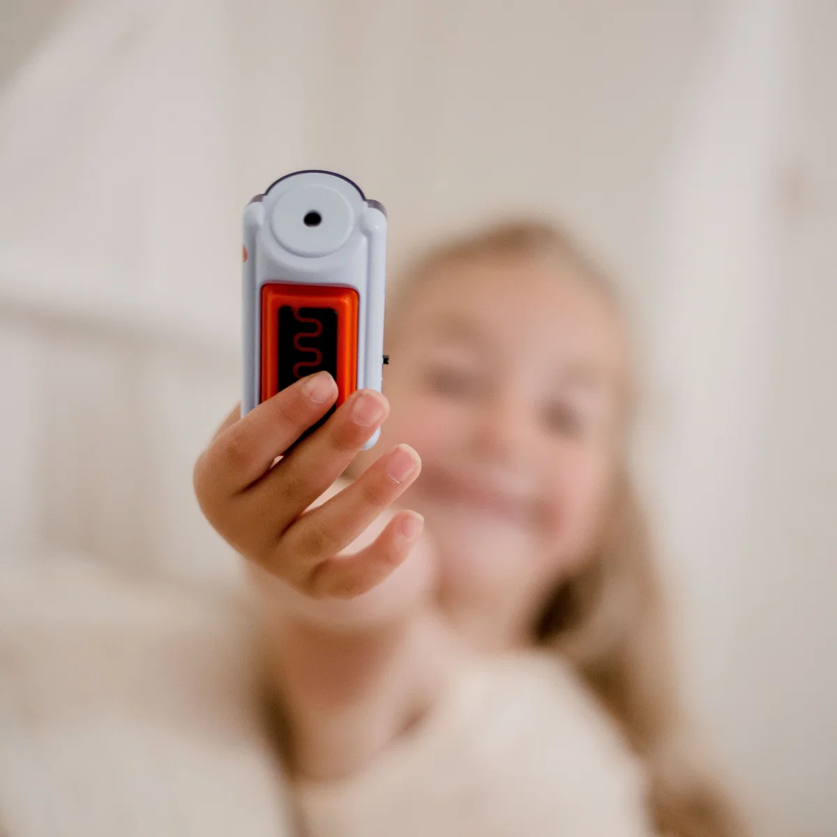 Child holding a DRI Sleeper Eclipse alarm