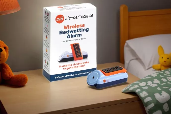 DRI Sleeper Eclipse bedwetting alarm beside a child's bed